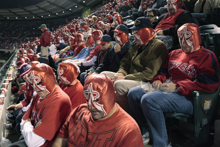 Image: Fans wear wrestling masks during the fifth inning of the MLB American League baseball game between the Los Angeles Angels and the Chicago White Sox in Anaheim